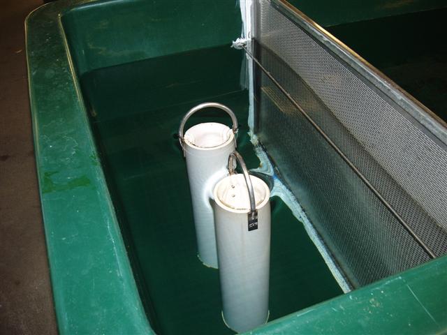 Drains in one raceway inside Hatchery, aluminum screen prevents fish from entering drain area (Small).jpg
