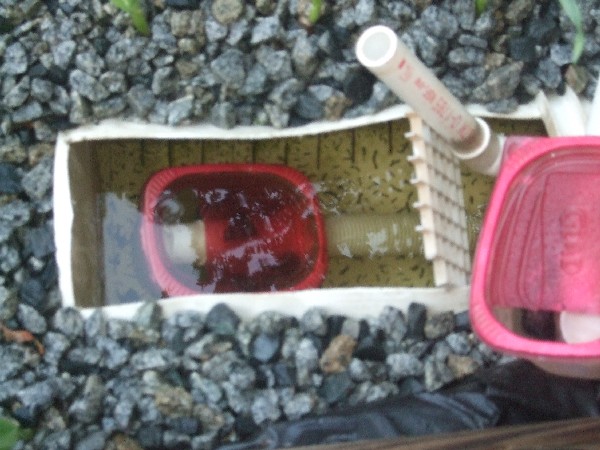 Doug's AP system - Home made flout (and backup) in drain area bucket.JPG